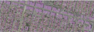 A grayscale satellite image of an urban area with building footprints highlighted in purple.